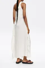 Vestido largo marrón de lino, con corte ajustado y fruncido. Presenta escote de un solo hombro con lazo y maxitira de tejido. Cierre con cremallera invisible lateral y pañuelos laterales.