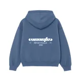 Buzo hoodie celeste de felpa, corte oversize, con capucha y puños acanalados. Estampado en la espalda con el texto "venefa" en tipografía futurista y la frase "WHERE FEAR FLIPS INTO YLE. STREET-BORN, FUTURE-BOUND.".