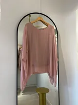 Blusa de seda italiana color rosa pálido, con cuello redondo, corte asimétrico y musculosa integrada.