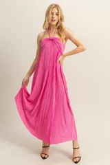 Vestido largo plisado color fucsia, con escote halter y espalda descubierta.