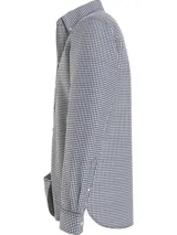 Camisa Tommy Hilfiger de corte regular, confeccionada en algodón orgánico Oxford con diseño de cuadros Vichy. Presenta cuello con botones, puños redondeados con dos botones y logo de Tommy Hilfiger bordado en el pecho.