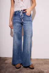Pantalón de jean de tiro medio, color celeste, corte flared y wide leg.