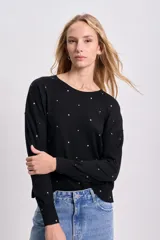 Buzo negro de punto fino con cuello redondo y tachas plateadas en forma de estrella.