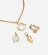 Pulsera dorada con dijes colgantes: flor con strass, caracola con nácar y caracola de metal.