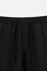 Pantalón azul marino de corte amplio, confeccionado en tejido de mezcla de algodón y lino. Cuenta con cintura elástica ajustable con cordón, bolsillos frontales y bolsillos traseros de vivo.