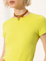 Remera de calce ajustado color amarillo, confeccionada en algodón con elastano. Presenta escote redondo cerrado en el frente, espalda cavada y mangas cortas estilo japonés que acompañan la silueta.