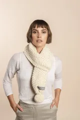 Bufanda tejida a mano en punto arroz color crudo, con detalle de pompón en uno de los extremos.
