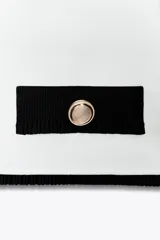 Top blanco de tejido elástico, con escote cuadrado y sisa. Presenta falsos bolsillos con botones metálicos dorados en el delantero y acabados a contraste en negro.