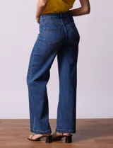 Jean baggy de tiro alto marca Baccini, corte wide leg, color azul denim. Cuenta con pretina con pasadores, botón y cierre. Delantera y trasera con bolsillos.