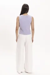 Pantalón blanco de corte palazzo, con cintura alta y pinzas delanteras.