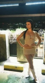Conjunto de top strapless con detalle cut-out y minifalda con cordones laterales, ambos de tela brillante color beige.