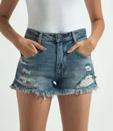 Short de jean boyfriend con cintura baja, forro aparente, roturas y terminación desflecada.
