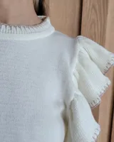 Musculosa blanca de punto con cuello redondo y mangas con volados.