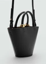 Bolso color verde oliva con forma trapezoidal, efecto piel, asa de mano y asa larga desmontable.