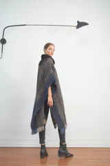 Poncho de tejido con patrón en zigzag, con flecos en los bordes.