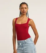 Body musculosa color rojo, de tejido seamless con textura acanalada y escote cuadrado.