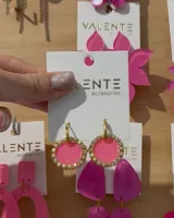 Aros colgantes con aro de acero dorado y dije circular de acrílico fucsia con borde de strass.