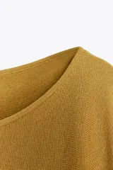 Top mostaza de punto con cuello redondo amplio y manga corta con tejido doble tipo capa.