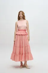 Vestido midi color lila, con cuerpo superior ajustado de punto canalé y falda amplia de tres niveles con textura arrugada.