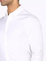Camisa de vestir blanca de manga larga, con cuello clásico y cierre con botones.