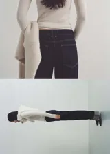 Pantalón de jean azul oscuro de corte recto con ruedo con dobladillo gris. Diseño de tiro medio, cinco bolsillos y cierre frontal con cremallera y botón.