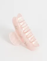 Broche para el pelo color rosa claro con forma de pinza y apliques de strass con forma de moño.