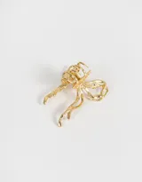 Broche para el pelo dorado con forma de moño.