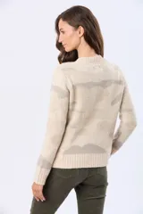 Buzo tejido de cuello redondo, color beige con estampado abstracto en tonos rosados y grises. Tiene mangas largas con puños acanalados y un pequeño parche de cuero sintético en el dobladillo.