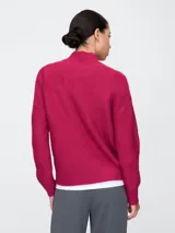 Sweater de punto trenzado color celeste con cuello alto.