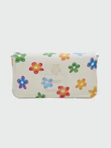 Cartera bandolera Marc Jacobs modelo The Mini Bag con estampado de margaritas de colores.