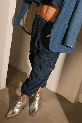 Pantalón cargo de denim azul con bolsillos laterales con tapa, cintura elastizada y pierna amplia.