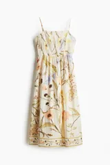 Vestido midi con estampado floral, de breteles finos ajustables y espalda fruncida.
