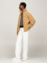 Campera color beige de tejido polar de peluche, con cuello alto, cierre de cremallera, bolsillos laterales y puños elásticos.