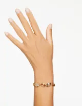 Pulsera dorada con cristales facetados marrones y dorados.