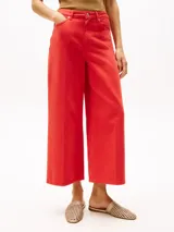 Pantalón jean de pierna ancha color rojo, de talle alto y corte tobillero.