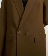 Blazer oversized color marrón con corte sastrero, solapas y cierre frontal con dos botones.