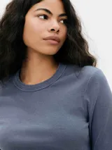 Camiseta azul de manga larga con cuello redondo y corte ajustado.