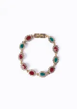 Pulsera dorada con eslabones de bronce y cristales rojos, verdes y blancos engarzados en forma floral.