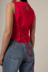 Top rojo sin mangas con botones frontales.
