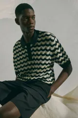 Short negro de tejido suave con cintura elástica y cordón ajustable oculto. Tiene bolsillos laterales discretos y bolsillos traseros ribeteados. Corte relajado.