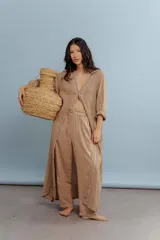 Túnica larga color beige de lino con bordados en el frente y mangas largas.