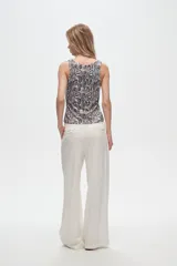 Pantalón de lino y viscosa color blanco, de corte ancho y tiro alto, con pinzas en la cintura.