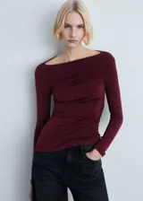 Camiseta de manga larga color borgoña con cuello barco y diseño drapeado en el frente.