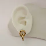 Par de aros colgantes dorados con forma de eslabones entrelazados.