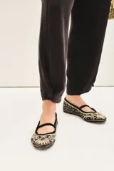 Pantalón sastrero color blanco, de tiro alto, con ajuste en el tobillo, bolsillos delanteros y traseros, y pinzas en el frente.