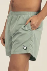 Short de baño gris claro, con cintura elástica ajustable, dos bolsillos laterales y uno trasero con cierre. Tiene suspensor de malla fina hipoalergénico y protección UV 50.