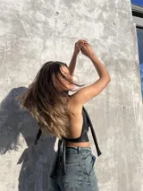 Top negro de ecocuero con cuello halter y espalda descubierta.