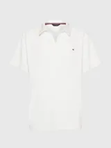 Chomba blanca de felpa de Tommy Hilfiger con cuello clásico, corte amplio, logo bordado en el pecho y detalles distintivos de la marca.