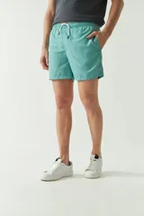 Short de baño liso color celeste, con cintura elástica ajustable con cordón, dos bolsillos laterales y uno trasero.