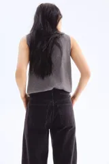 Pantalón de jean negro de corte ancho, tiro alto y largo tobillero.